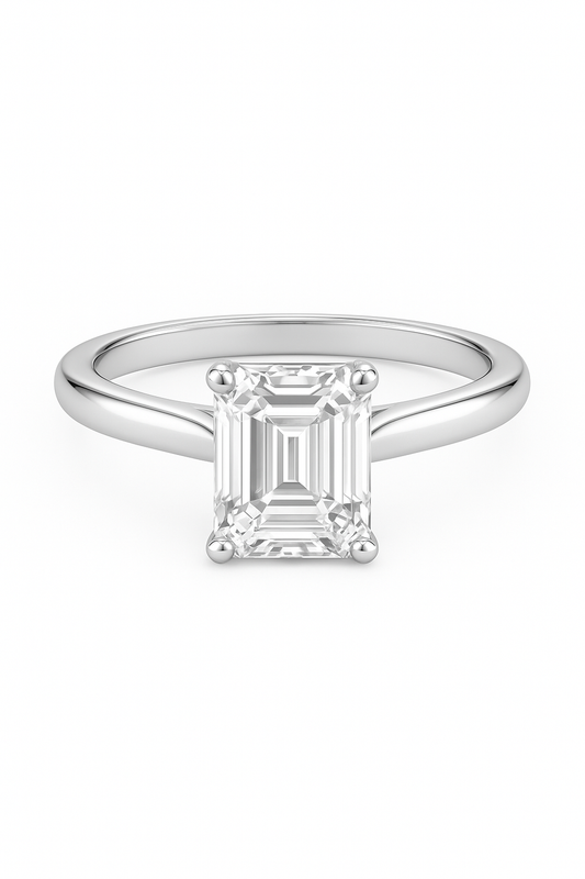 Emerald cut natural diamond ring in 18k white gold by Luxe Alchemy on white background